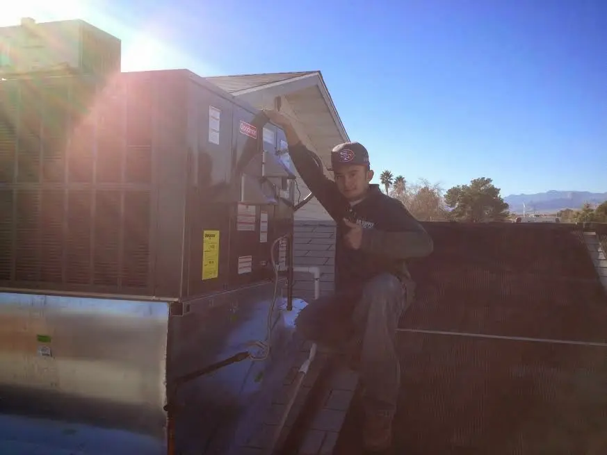 HVAC technician performing HVAC Inspection on a rooftop unit in Dothan